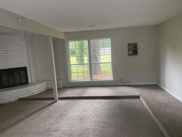 30714 Meadow Wood Dr, Magnolia, TX 77354 - unfurnished living room with carpet floors, electric panel, a fireplace, and baseboards