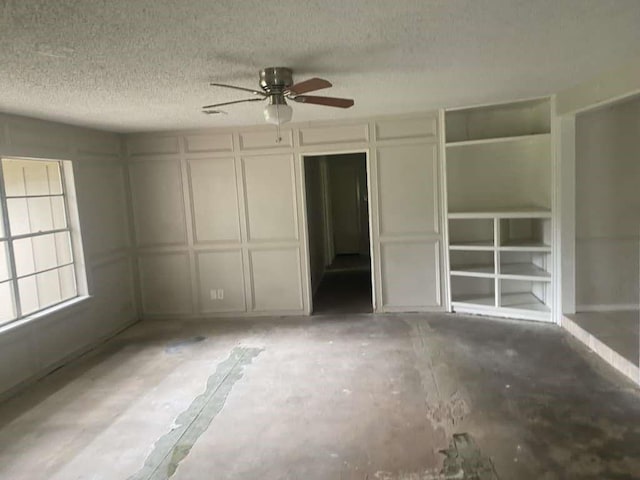 30714 Meadow Wood Dr, Magnolia, TX 77354 - unfurnished bedroom with a textured ceiling, a decorative wall, and a ceiling fan