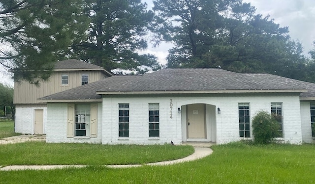 30714 Meadow Wood Dr, Magnolia, TX 77354 - view of front facade with a front lawn, a shingled roof, and brick siding