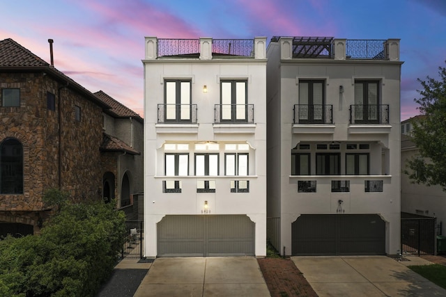 5420 Mcculloch Cir, Houston, TX 77056 - view of front of property with a balcony, stucco siding, and an attached garage
