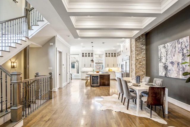 5420 Mcculloch Cir, Houston, TX 77056 - dining area with light wood-style floors, plenty of natural light, ornamental molding, beverage cooler, and baseboards