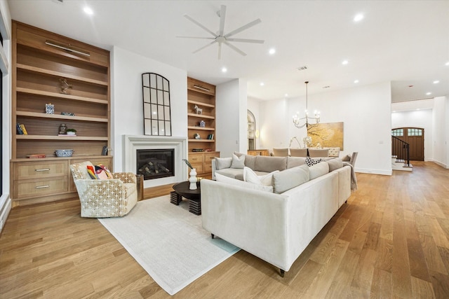 1314 Richelieu Ln, Houston, TX 77018 - living area featuring a glass covered fireplace, a ceiling fan, light wood-style floors, built in features, and recessed lighting