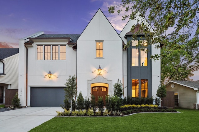 1314 Richelieu Ln, Houston, TX 77018 - view of front of house with stucco siding, an attached garage, driveway, a front yard, and a shingled roof