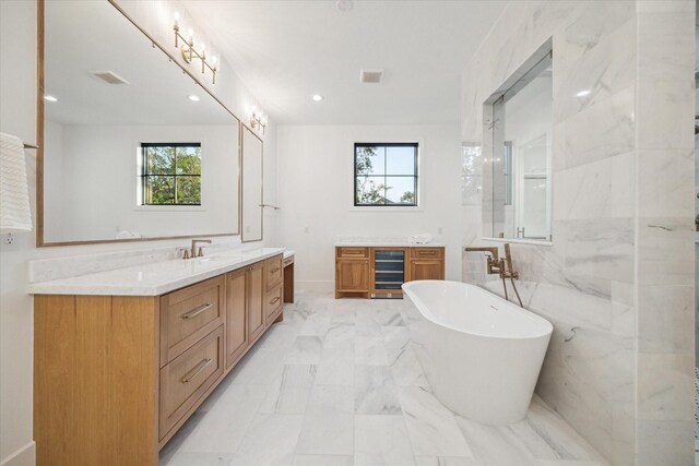 1314 Richelieu Ln, Houston, TX 77018 - bathroom featuring beverage cooler, vanity, healthy amount of natural light, a soaking tub, and recessed lighting