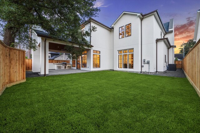 1314 Richelieu Ln, Houston, TX 77018 - back of property at dusk with a patio and central AC unit