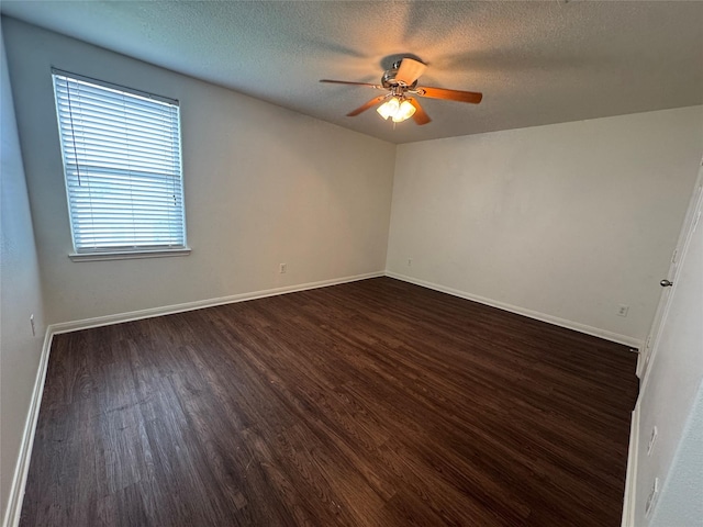 914 Paradise Rd, Baytown, TX 77521 - unfurnished room with dark wood-style flooring, ceiling fan, a textured ceiling, and baseboards