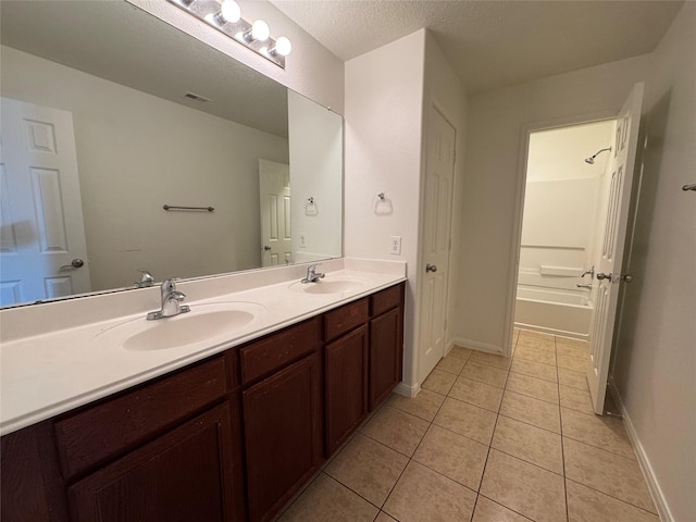 914 Paradise Rd, Baytown, TX 77521 - bathroom featuring double vanity, tile patterned flooring, and baseboards
