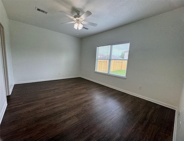 914 Paradise Rd, Baytown, TX 77521 - unfurnished room with dark wood-style flooring, ceiling fan, baseboards, and a textured ceiling