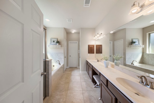 813 Woodland Ct, Conroe, TX 77302 - bathroom featuring double vanity, a garden tub, tile patterned flooring, and baseboards