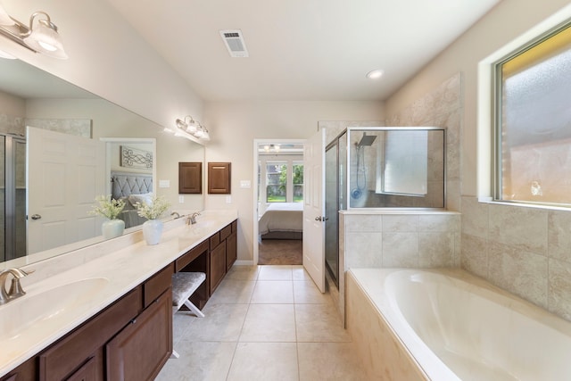 813 Woodland Ct, Conroe, TX 77302 - ensuite bathroom featuring double vanity, a garden tub, a stall shower, and tile patterned floors