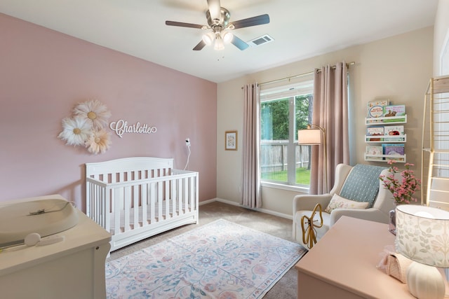 813 Woodland Ct, Conroe, TX 77302 - bedroom with baseboards, a nursery area, carpet flooring, and ceiling fan