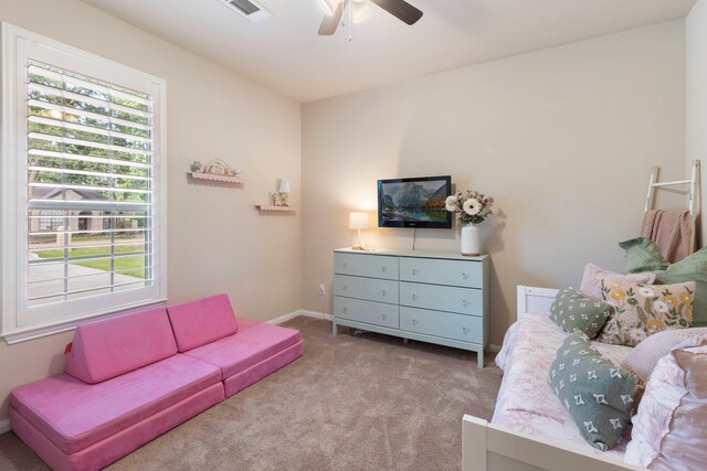813 Woodland Ct, Conroe, TX 77302 - bedroom with multiple windows, carpet, a ceiling fan, and baseboards