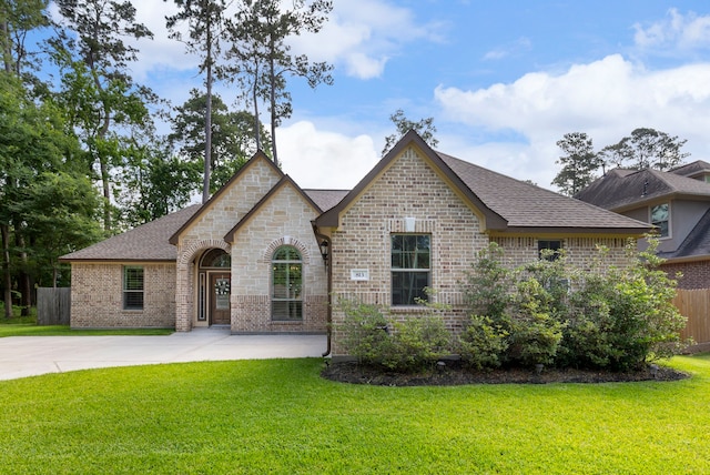 813 Woodland Ct, Conroe, TX 77302 - french country inspired facade with brick siding and roof with shingles