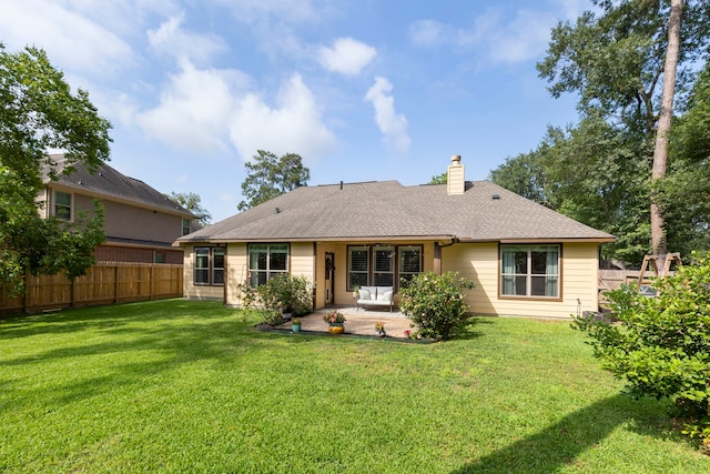 813 Woodland Ct, Conroe, TX 77302 - rear view of house featuring a patio, a chimney, and roof with shingles