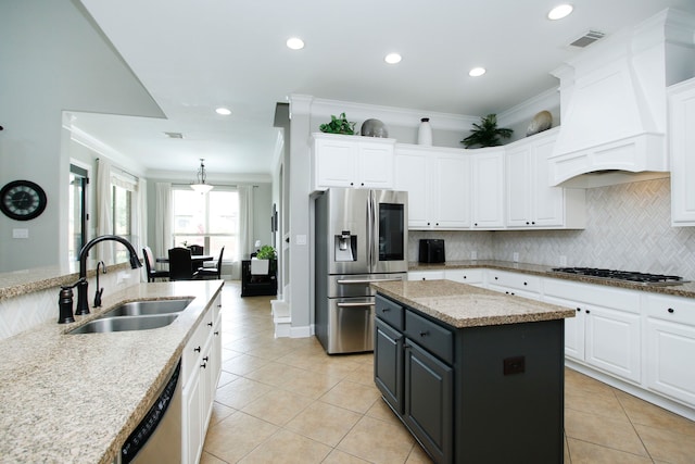 9303 Georgetown Glen Cir, Cypress, TX 77433 - kitchen with stainless steel appliances, a sink, custom range hood, white cabinets, and ornamental molding