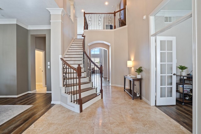 18430 S Settlers Shore Dr, Cypress, TX 77433 - foyer entrance with arched walkways, stairs, baseboards, ornamental molding, and a towering ceiling