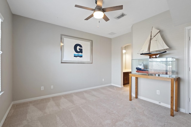 18430 S Settlers Shore Dr, Cypress, TX 77433 - unfurnished living room with arched walkways, a ceiling fan, light colored carpet, and baseboards