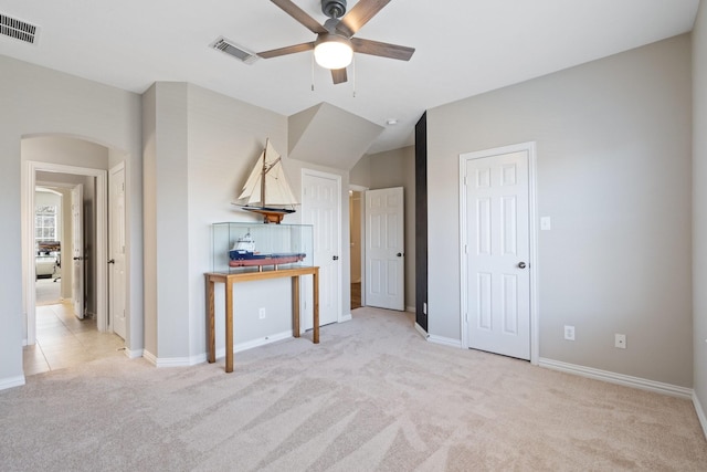 18430 S Settlers Shore Dr, Cypress, TX 77433 - unfurnished living room with arched walkways, light colored carpet, a ceiling fan, and baseboards