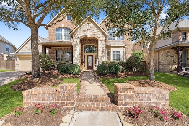 18430 S Settlers Shore Dr, Cypress, TX 77433 - view of front of house with stone siding, brick siding, and driveway
