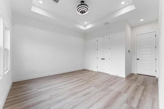 503 Nimrod St, Houston, TX 77020 - unfurnished bedroom featuring a raised ceiling, recessed lighting, light wood-type flooring, baseboards, and a closet