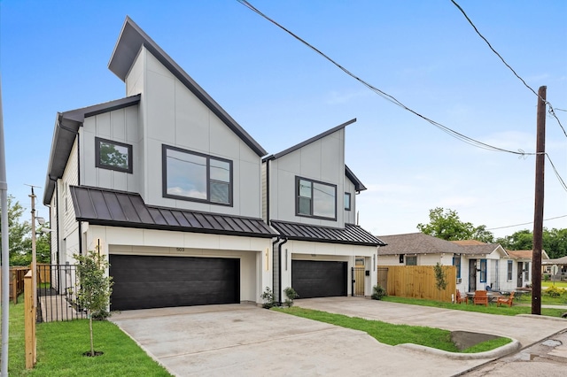 503 Nimrod St, Houston, TX 77020 - view of front of property featuring concrete driveway, an attached garage, and a standing seam roof