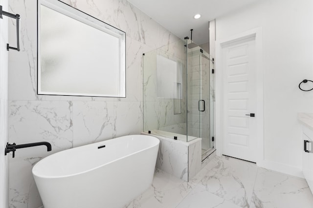 503 Nimrod St, Houston, TX 77020 - bathroom featuring marble tiled flooring, a marble finish shower, a soaking tub, vanity, and recessed lighting