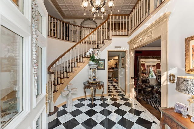 1561 Kirby Dr, Houston, TX 77019 - entrance foyer with a towering ceiling, stairs, a chandelier, and ornamental molding