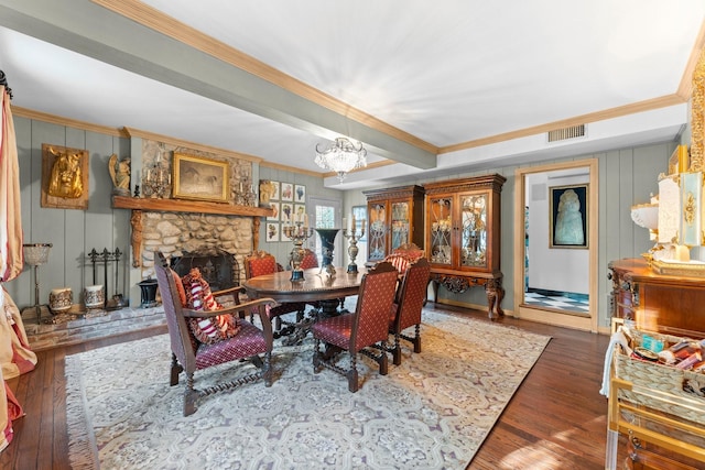 1561 Kirby Dr, Houston, TX 77019 - dining area featuring crown molding, hardwood / wood-style flooring, a chandelier, and a stone fireplace