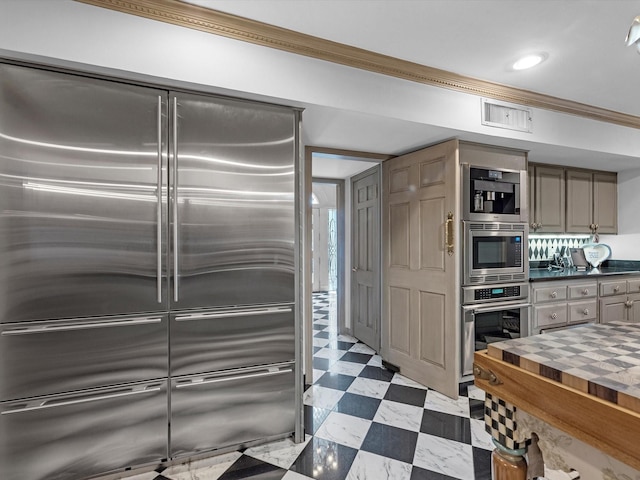 1561 Kirby Dr, Houston, TX 77019 - kitchen featuring stainless steel appliances, light floors, ornamental molding, and recessed lighting