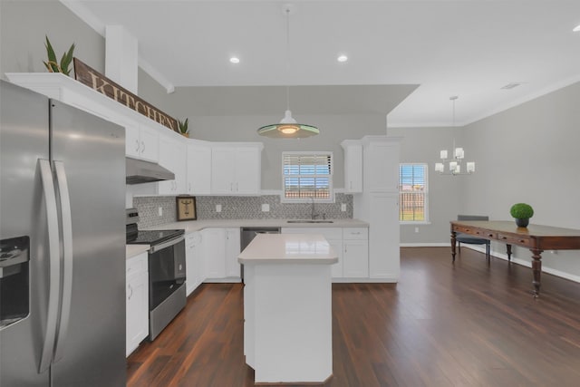 9206 Gene St, Needville, TX 77461 - kitchen featuring appliances with stainless steel finishes, under cabinet range hood, light countertops, tasteful backsplash, and dark wood finished floors