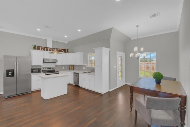 9206 Gene St, Needville, TX 77461 - kitchen featuring stainless steel appliances, a center island, decorative backsplash, dark wood-type flooring, and a chandelier
