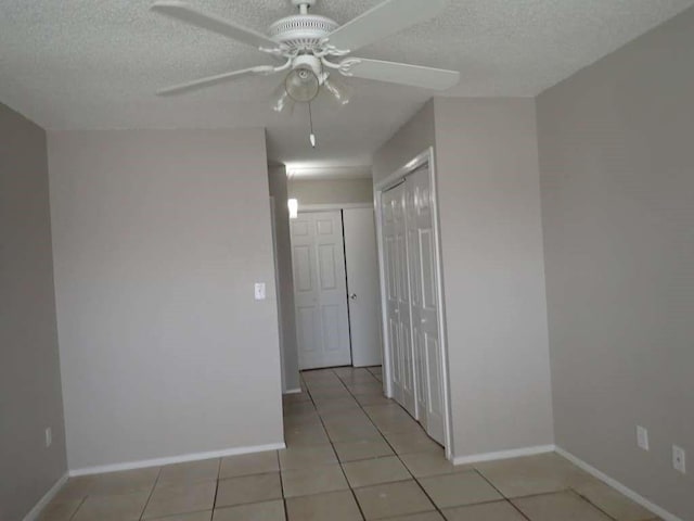6383 Dryad Dr Unit 638, Houston, TX 77035 - spare room with a ceiling fan, a textured ceiling, light tile patterned floors, and baseboards