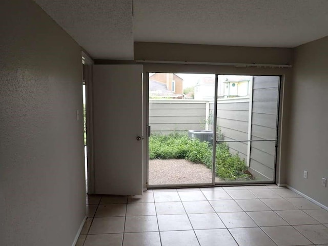 6383 Dryad Dr Unit 638, Houston, TX 77035 - spare room with light tile patterned floors, a textured ceiling, and baseboards
