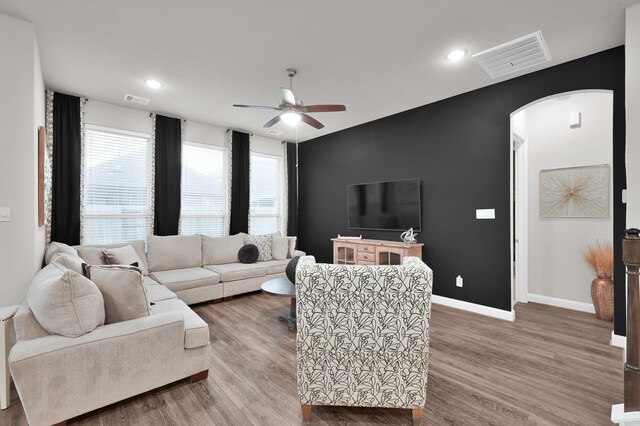 17413 Turtleweed Ln, Conroe, TX 77385 - living area featuring arched walkways, ceiling fan, wood finished floors, baseboards, and recessed lighting