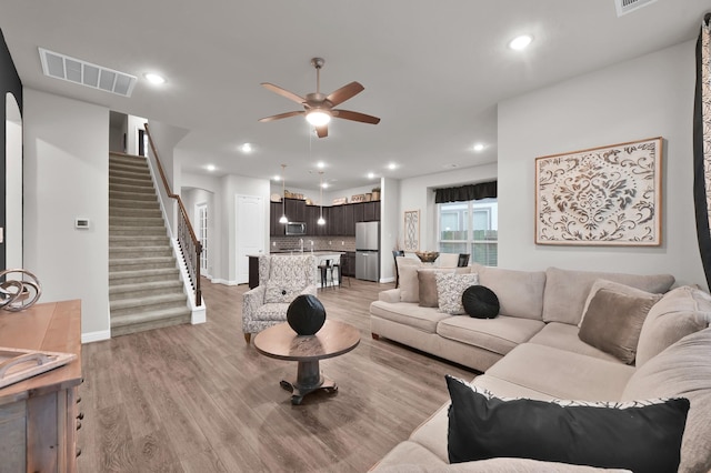 17413 Turtleweed Ln, Conroe, TX 77385 - living area featuring a ceiling fan, light wood-style flooring, stairway, recessed lighting, and baseboards