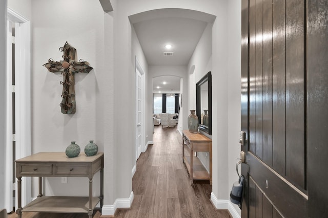 17413 Turtleweed Ln, Conroe, TX 77385 - hall featuring arched walkways, dark wood-style flooring, and baseboards