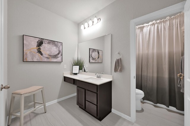 17413 Turtleweed Ln, Conroe, TX 77385 - bathroom featuring toilet, vanity, and baseboards