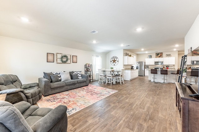 128 Barton Creek Dr, Huntsville, TX 77340 - living area featuring wood finished floors and recessed lighting