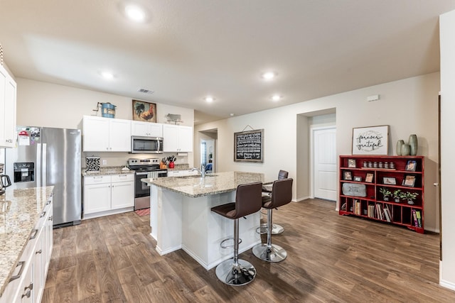128 Barton Creek Dr, Huntsville, TX 77340 - kitchen featuring stainless steel appliances, a sink, dark wood finished floors, white cabinetry, and recessed lighting
