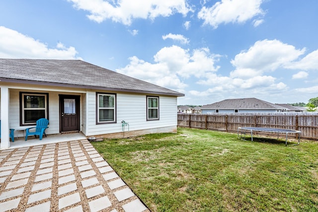 128 Barton Creek Dr, Huntsville, TX 77340 - view of yard featuring a trampoline and a porch