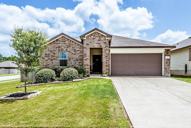 128 Barton Creek Dr, Huntsville, TX 77340 - view of front facade featuring brick siding, driveway, a garage, and a front lawn