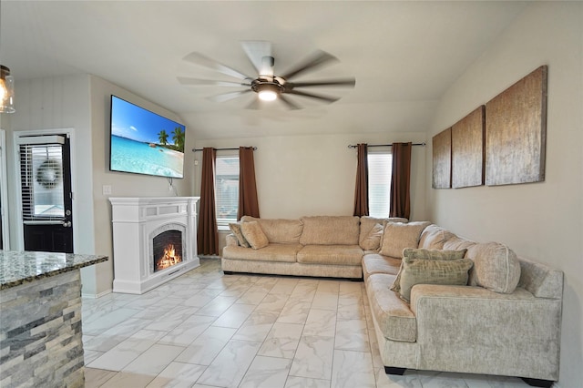 15482 Sicomoro Viejo St, Channelview, TX 77530 - living room featuring ceiling fan, light marble finish floors, a lit fireplace, and vaulted ceiling