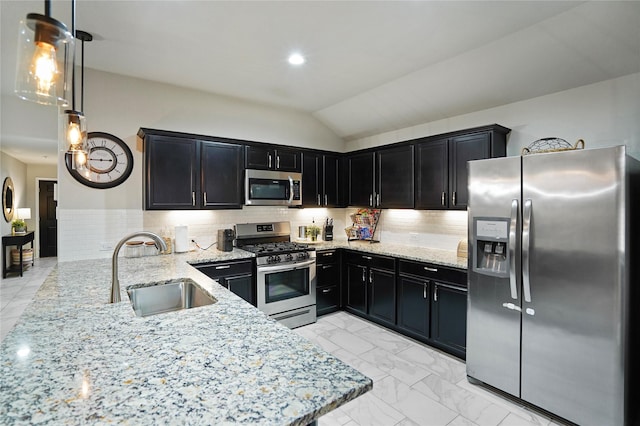 15482 Sicomoro Viejo St, Channelview, TX 77530 - kitchen featuring appliances with stainless steel finishes, a sink, dark cabinetry, light stone countertops, and tasteful backsplash