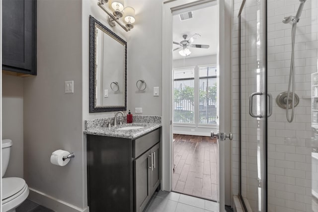 3909 Rose St, Houston, TX 77007 - full bathroom with ceiling fan, toilet, a shower stall, vanity, and baseboards