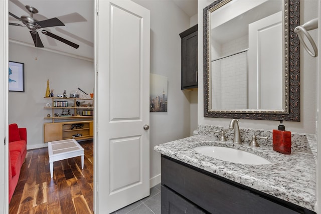 3909 Rose St, Houston, TX 77007 - bathroom featuring ceiling fan, vanity, baseboards, a shower, and wood finished floors