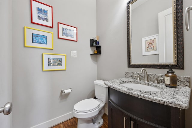 3909 Rose St, Houston, TX 77007 - half bathroom with wood finished floors, vanity, toilet, and baseboards