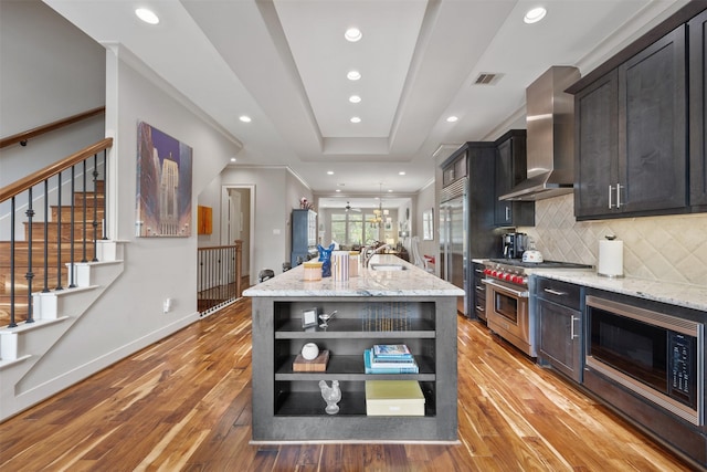 3909 Rose St, Houston, TX 77007 - kitchen with built in appliances, wall chimney range hood, open shelves, a sink, and light wood-type flooring