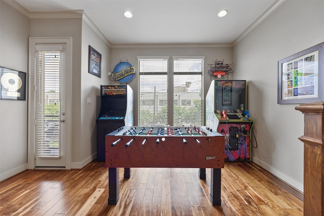 3909 Rose St, Houston, TX 77007 - recreation room featuring crown molding, wood-type flooring, baseboards, plenty of natural light, and recessed lighting