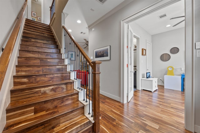 3909 Rose St, Houston, TX 77007 - stairway with a ceiling fan, wood finished floors, baseboards, and recessed lighting