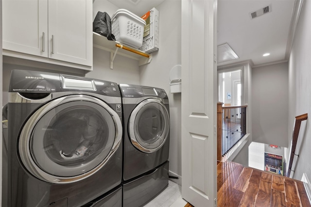 3909 Rose St, Houston, TX 77007 - washroom with washing machine and clothes dryer, ornamental molding, and light wood-style floors